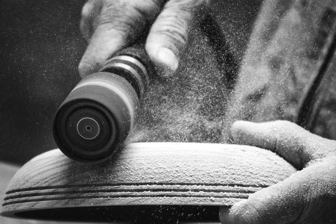 Guinevere Basic Sanding Kit for Woodworking and Finishing shaping a wooden bowl with a rotary tool attachment and sandpaper.
