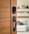 SmartCode 915 Touchscreen Electronic Deadbolt With Smart Key UL Listed Illuminated Keypad installed on wooden door in living room.