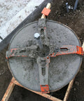24 Inch Reusable Pole Base Template for Quick Setup installed in sandy ground with bolts and supporting rim visible.