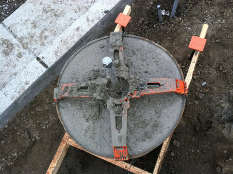 24 Inch Reusable Pole Base Template for Quick Setup installed in sandy ground with bolts and supporting rim visible.