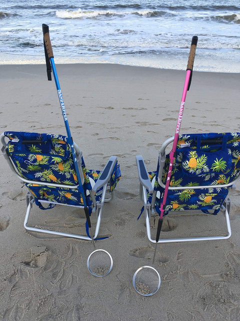 Beach Dipper Sifter Shovel for Beachcombing with 6 Inch Basket and adjustable walking stick, blue and pink, leaning on beach chairs