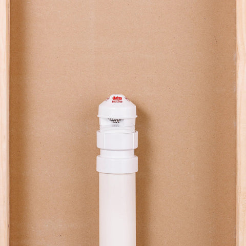 Front view of a white Oatey Sure-Vent air admittance valve on a PVC pipe