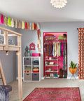 Room with Maximizer Closet Organizer Add On Unit With Four Shelves And Double Hang Rod, curtains, bed, and decor.