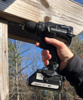 Person using 18V Brushless Cordless Drill Driver With LED Light Tough As Nails Powerhouse Performance 620 Inch Pounds Torque Keyless Chuck 22 Clutch Settings Includes Bit And Charger Black Finish Lifetime Tool Warranty on wood outdoors.