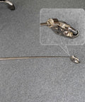 Telescoping Magnetic Pickup Tool With 20 Lb Pull Strength, Extends From 7 To 31 Inches shown with metal tip close-up on gray carpet