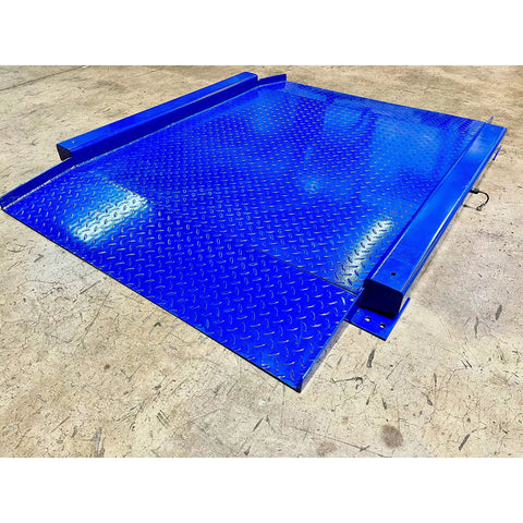 Heavy Duty Low Profile Drum Scale Built Tough With Smooth Hinged Ramps For No Sweat Barrel Rolling And Rock Solid Weighing Capability Up To 5000 Pounds With Spot On One Pound Accuracy NTEP Approved blue steel platform with diamond plate texture.