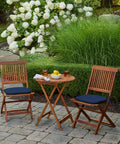 Outdoor scene with two wooden chairs featuring Indoor Outdoor Foam Seat Pad Set, 2 Pack, 17 By 16 Inch Patio Cushions, Sapphire Blue Leala.