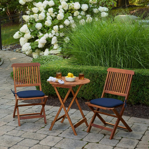 Outdoor scene with two wooden chairs featuring Indoor Outdoor Foam Seat Pad Set, 2 Pack, 17 By 16 Inch Patio Cushions, Sapphire Blue Leala.