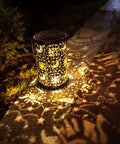 Outdoor Solar Lanterns For Garden Decor with sun moon star pattern glowing on pathway, brown bronze metal finish