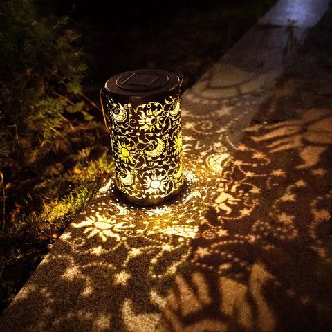 Outdoor Solar Lanterns For Garden Decor with sun moon star pattern glowing on pathway, brown bronze metal finish