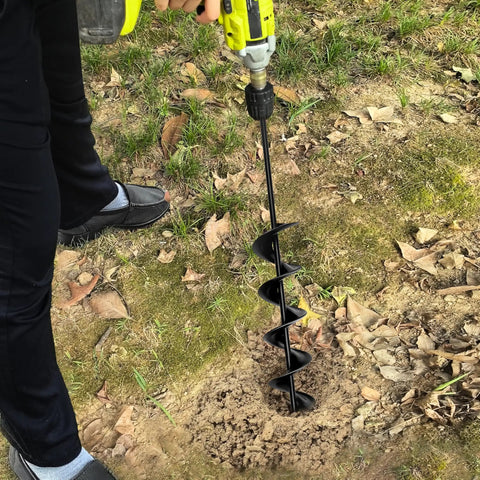 Person using heavy duty 3 inch by 24 inch garden auger drill bit for planting and post hole digging with upgraded spiral design.