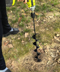 Person using auger drill bit for planting 4 x 12 inch bulb planter for cordless drill with three eighths inch hex drive.