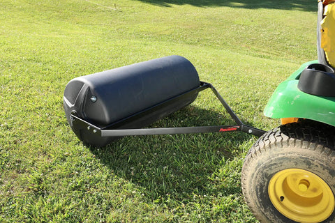 Tow Behind Lawn Roller 18-Inch By 36-Inch Heavy Duty Poly Roller With 40 Gallon Capacity attached to lawn mower on grass