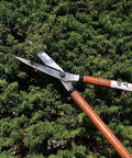 Heavy Duty 27 Inch Hedge Shears For Garden Pruning And Border Trimming Long Handle Professional Hedge Clippers In Use On Bush