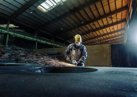 Worker using 7 Inch Angle Grinder With 8500 RPM And 15 Amp Power in metal workshop