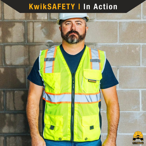 Person wearing Classic Safety Vest 2 Pack Class 2 ANSI OSHA HiVis Reflective Mesh Breathable Rugged Heavy Duty With 10 Pockets Front Zipper Orange Small Work Gear On The Job Site.