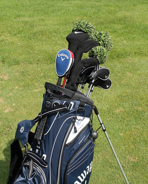 Golf bag with clubs on grass beside water golf ball retriever telescoping to 15 feet with ergonomic grip handle