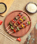 Grilled kebabs with vegetables on 200 Pack Bamboo Skewers 12 Inch Wooden Kabob Sticks For Appetizers And Grilling on a wooden plate 