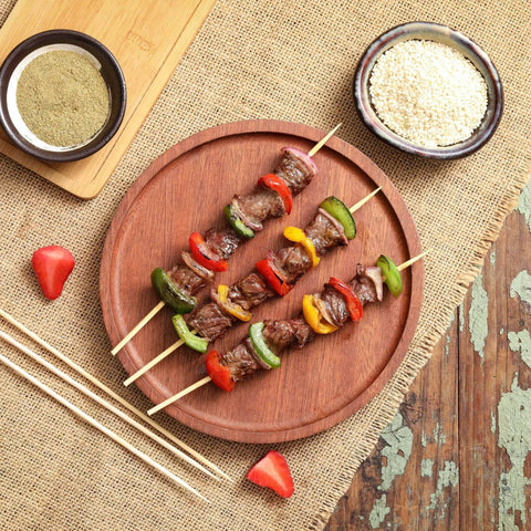 Grilled kebabs with vegetables on 200 Pack Bamboo Skewers 12 Inch Wooden Kabob Sticks For Appetizers And Grilling on a wooden plate 