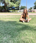 4K Camera Drone For Kids And Adults, Foldable Silent Quadcopter With 120 Degree Wide Lens hovering near girl on grass
