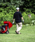 Man transporting Heavy Duty 301cc Chipper Shredder with 4 Cycle Viper Engine, Dock and Lock Debris Bag, 3 Inch Max Wood Diameter, Red.