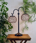 Castillo Outdoor Table Lamp in Oil Rubbed Bronze with Woven Rattan Shades, Rustic Two-Light 29 Inch Patio Lamp on wooden table