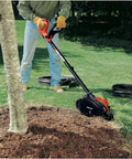 Man using 2 In 1 Electric Lawn Edger And Trencher With 12 Amp Corded Power, 7.5 Inch Cutting Width, in yard for edging