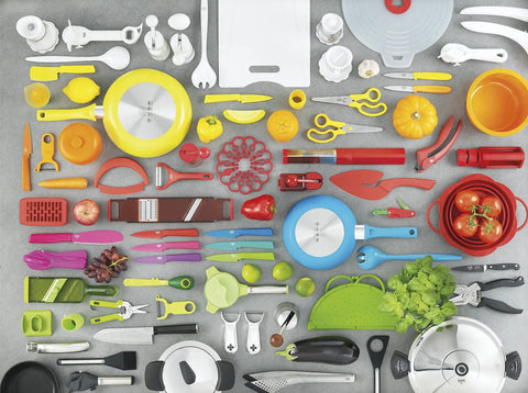 Assorted colorful kitchen utensils on gray surface including knives, peelers, pans, and yellow Ultra Sharp 8 Inch Kitchen Shears And Garden Snips In Red With Safety Lock, A Workhorse For Cutting In The Kitchen Or Yard, Multipurpose Snips For Quick Clean Cuts, Great Gift Idea.