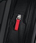 Samsonite Omni PC hardside carry-on luggage, black, close-up of red zipper pull, 20-inch