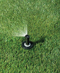 Top Notch Quarter Circle Spray Nozzle Covers Eight To Fifteen Feet spraying water onto lush grass, designed for efficient yard watering.
