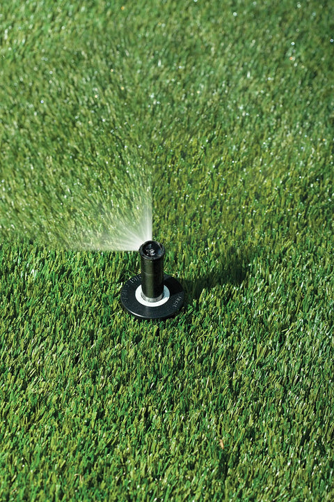 Top Notch Quarter Circle Spray Nozzle Covers Eight To Fifteen Feet spraying water onto lush grass, designed for efficient yard watering.