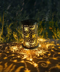 Outdoor Solar Lanterns For Garden Decor, Hanging Metal Sun Moon Star Lights casting patterns on ground in garden setting