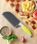 VRUIFA crinkle cutter with yellow non-slip handle on a wooden cutting board beside vegetables and pasta