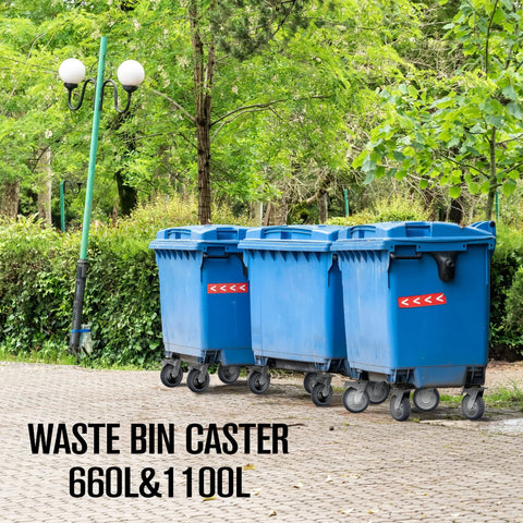 Set of four blue plastic waste bins on wheels outdoors among trees