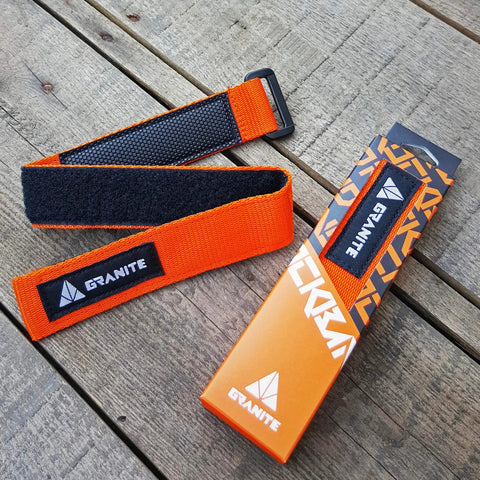 Rockband Bicycle Gear Carrier Strap in Orange No Drop Mount beside packaging on wooden surface