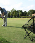 Golfer practicing with Collapsible Golf Chipping Net 23 Inch Folding Frame With 3 Target Baskets Portable Practice Net on a golf course