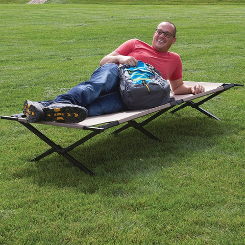 Person lounging on Trailhead II Large Folding Camping Cot With Easy Setup And Takedown, Supports Up To 300 Lbs, Stands 6 Ft 2 In Tall