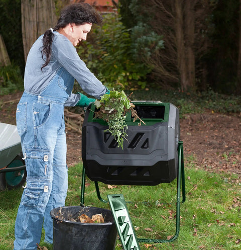 Person using Mr Spin Compost Tumbler With Dual Chamber Design 160 Liter 43 Gallon Capacity Two Leg Stand Green And Black.
