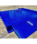 Heavy Duty Low Profile Drum Scale Built Tough With Smooth Hinged Ramps showing blue steel platform for easy barrel rolling.