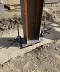 Viking Arm handheld jack/clamp with dual clamps on steel I-beam base at construction site.
