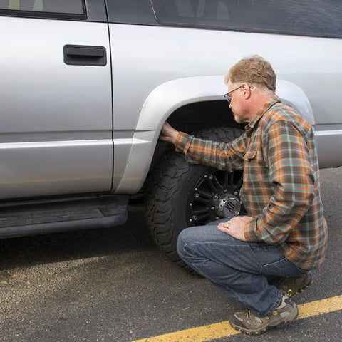 Man placing Waterproof Magnetic Key Box For Spare Keys With Secure Magnetic Key Holder And Box under car wheel well
