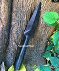 Hand Forged Viking Saga Iron Spear Point for Reenactment against tree with leaves, carbon steel, antique style