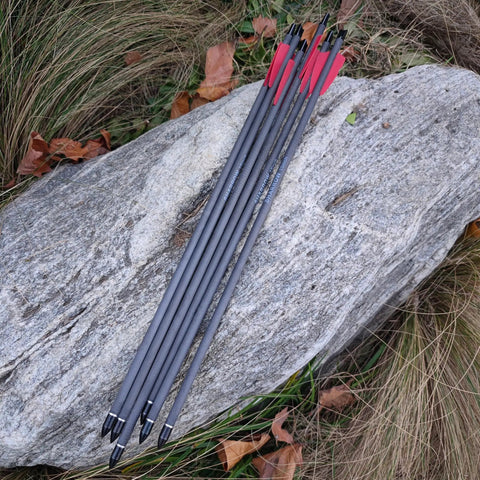 Carbon Crossbow Bolts 15 Inch With 100 Grain Removable Tips on rock surface outdoors