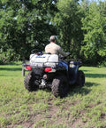 ATV mounted with 15 Gallon ATV Boomless Broadcast Sprayer With 16 Foot Swath, 2.2 GPM On Demand Diaphragm Pump in use on field