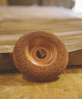 Professional Tungsten Carbide Shaping Disc For Woodworking Angle Grinders 4 Half Inch Diameter And 7 Eighth Inch Bore on wooden surface.