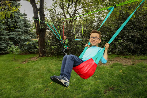 Child swinging on Classic Mesh Swing Seat for Swing Sets Kids 3 and Up Easy to Attach Backyard Playground Accessory in park.