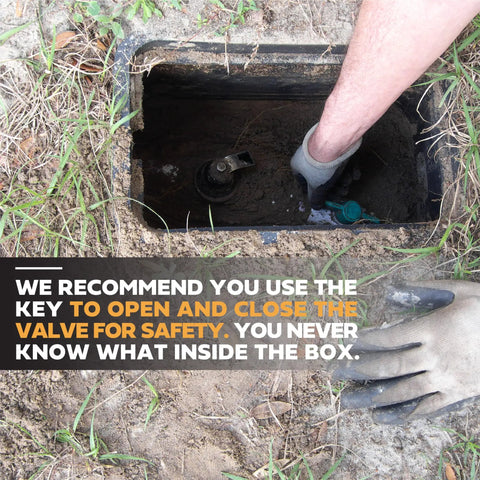 Person using Long Reach 48 Inch Water Meter Key With Wide T Handle For Easy Valve Access in a ground box.