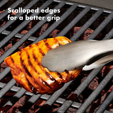 Scalloped tongs from Three Piece Grilling Tool Set With Stainless Steel Turner Scalloped Tongs And Silicone Tool Rest Built In Bottle Opener Non Slip Grip And Tong Holder Designed For One Handed Use With Extra Leverage From A Double Bend holding grilled chicken
