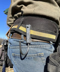 Universal Tool Holder Belt Hook for cordless drills shown on a worker's belt, made in USA, left or right hand use, CNC aluminum design.