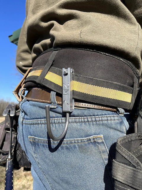 Universal Tool Holder Belt Hook for cordless drills shown on a worker's belt, made in USA, left or right hand use, CNC aluminum design.